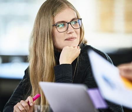 Woman in meeting listening to colleague