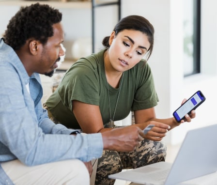 Veteran woman and man looking at laptop together
